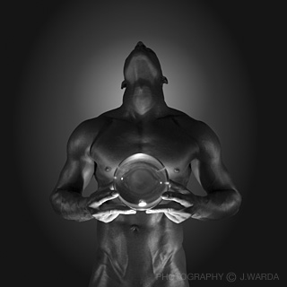 Black and White photo of a male nude model torso holding a glass ball fine art nude photography by j-warda the naked pixel